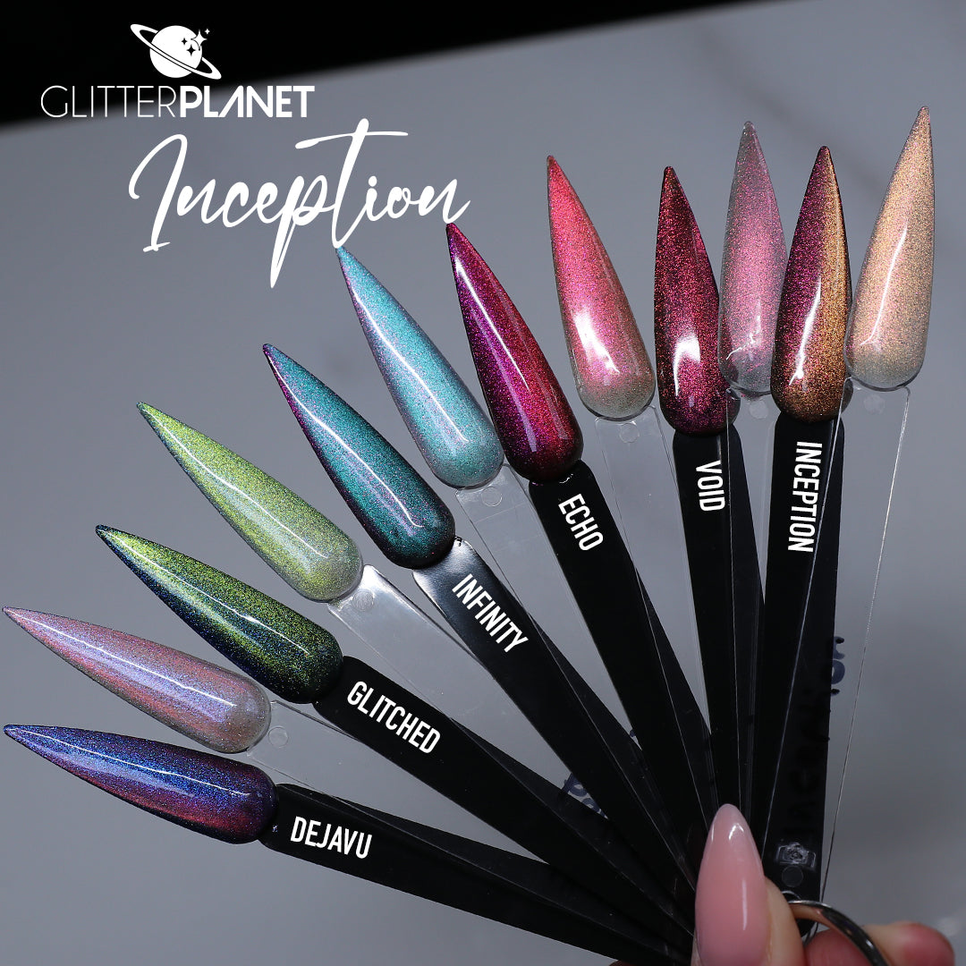 A fan of glitter nail polish samples on black swatch sticks held by a hand, with the brand name Glitter Planet and the shade name Inception visible. The shades include holographic pink, teal, green, lavender, blue, and rose gold.