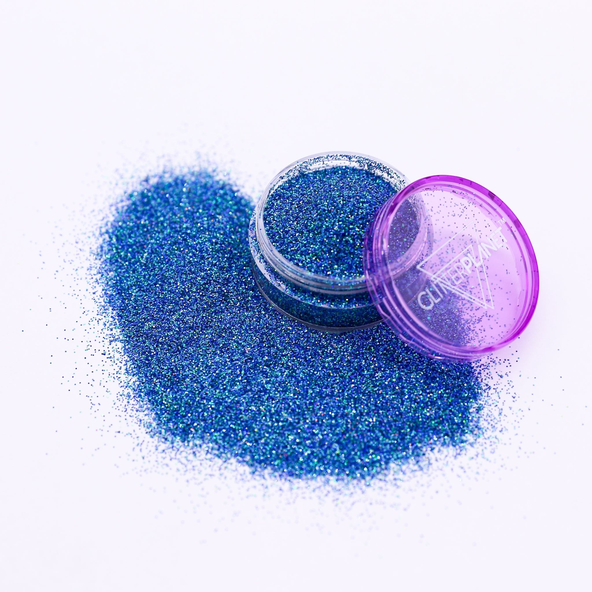 Blue glitter with a purple lid on a white background