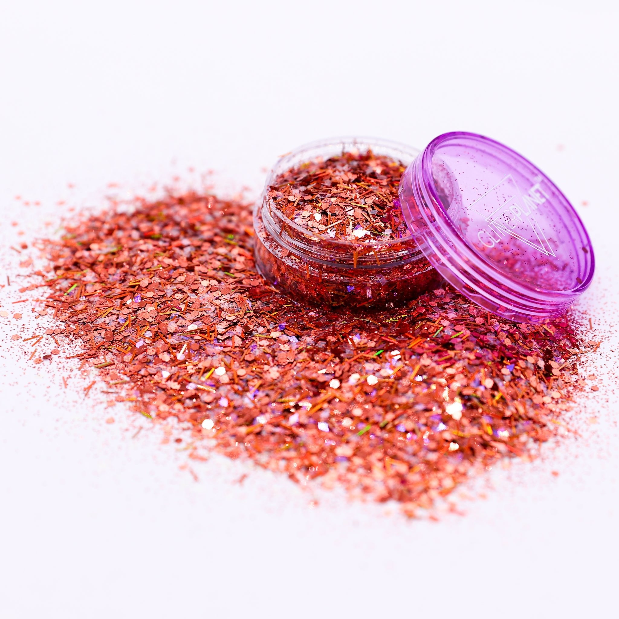 Bronze glitter jar with open lid on a white background