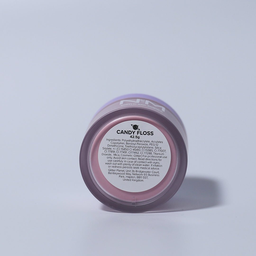 A jar of candy floss pink acrylic nail powder with nail mate logo in white with a matte finish lilac lid. the jar in on a white backdrop the jar is on its side revealing the ingredients label on the bottom of the jar