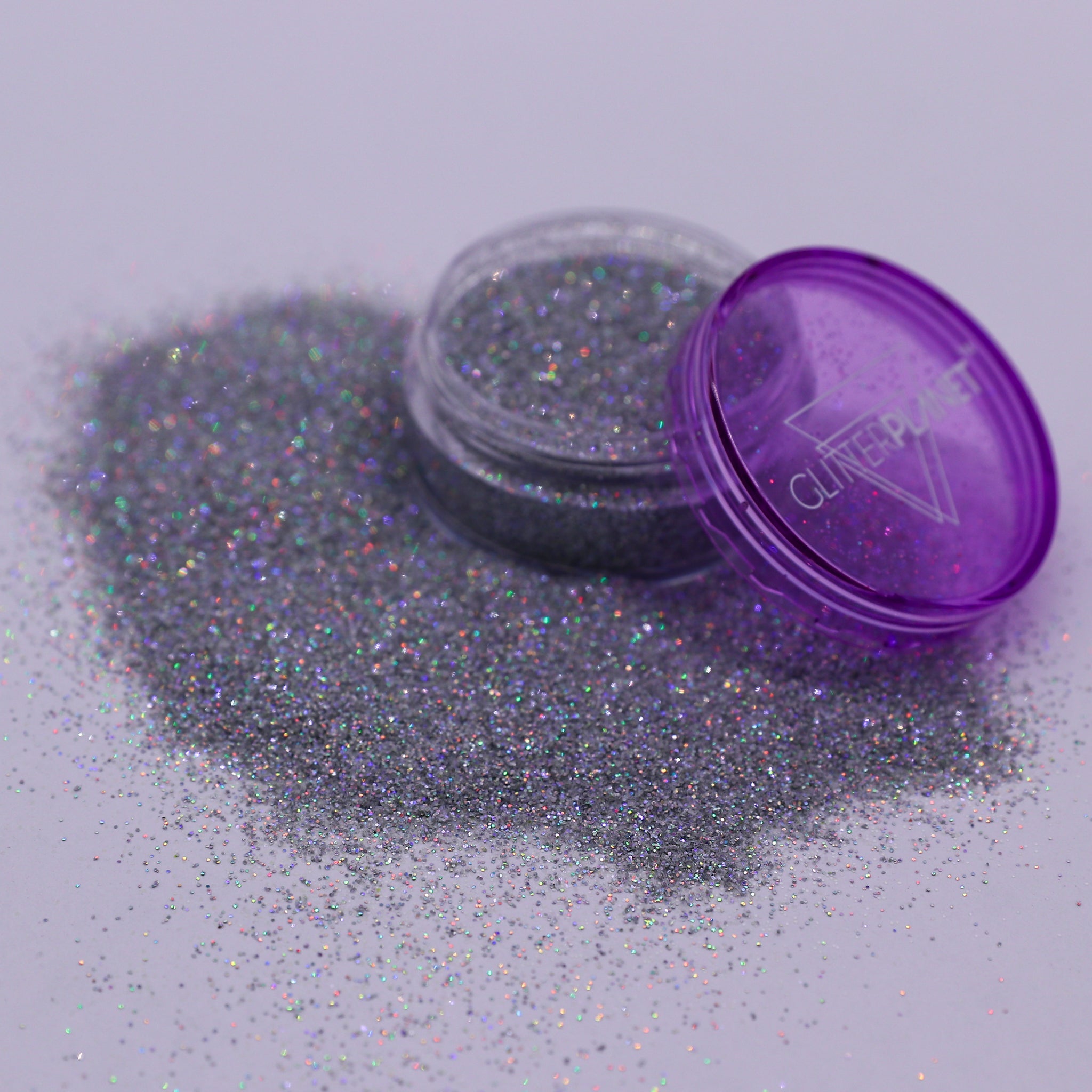 Purple glitter container with open lid on a light gray background | Glitter Planet