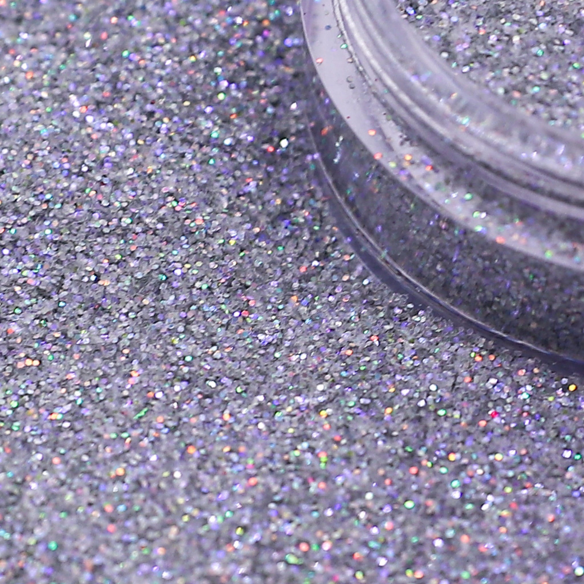 Close-up of silver glitter with a clear container partially filled with glitter | Glitter Planet