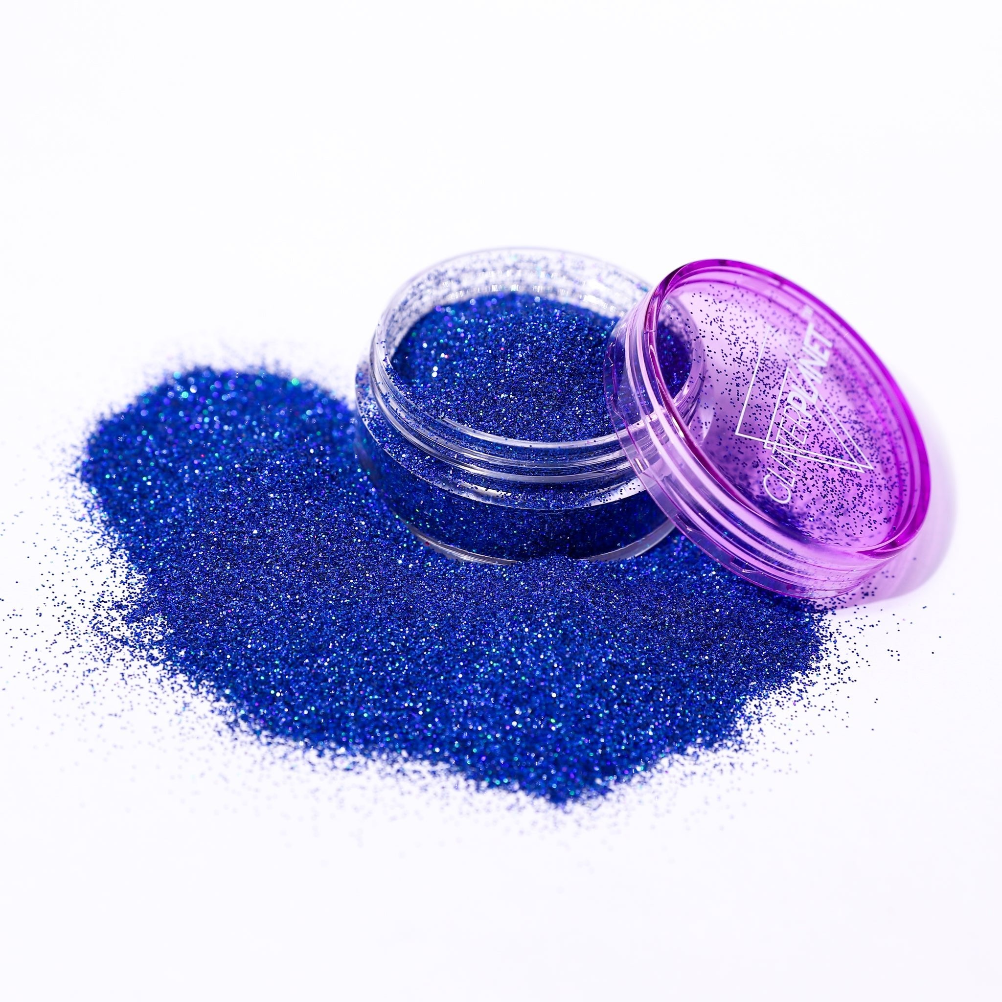 Fine holographic Blue nail glitter in a jar spilled out with the branding Glitter Planet