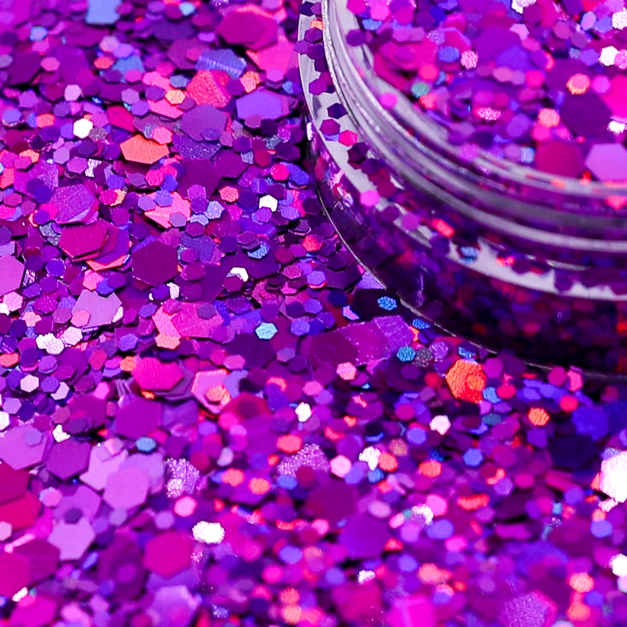 Purple glitter with a jar of glitter in the background