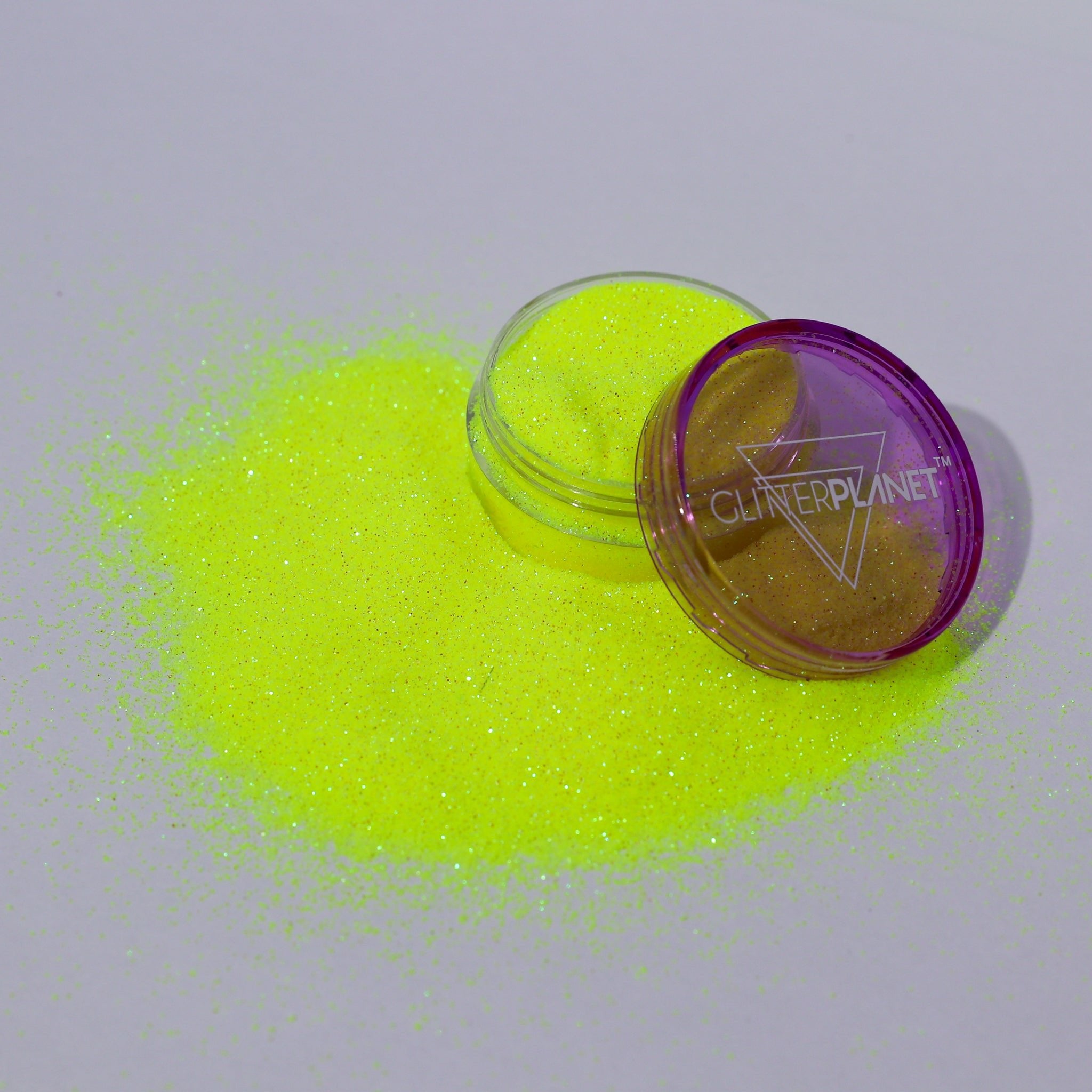 Neon yellow glitter with a purple container labeled &