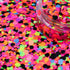Colorful glitter with a clear container on a multicolored glitter background