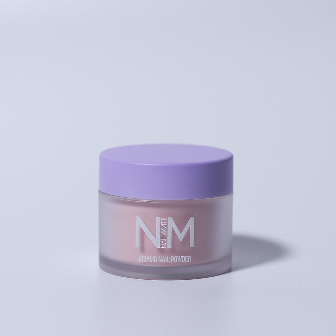 A container of Pirouette shimmer core acrylic nail powder in light pink color with a purple lid, branded with NM.