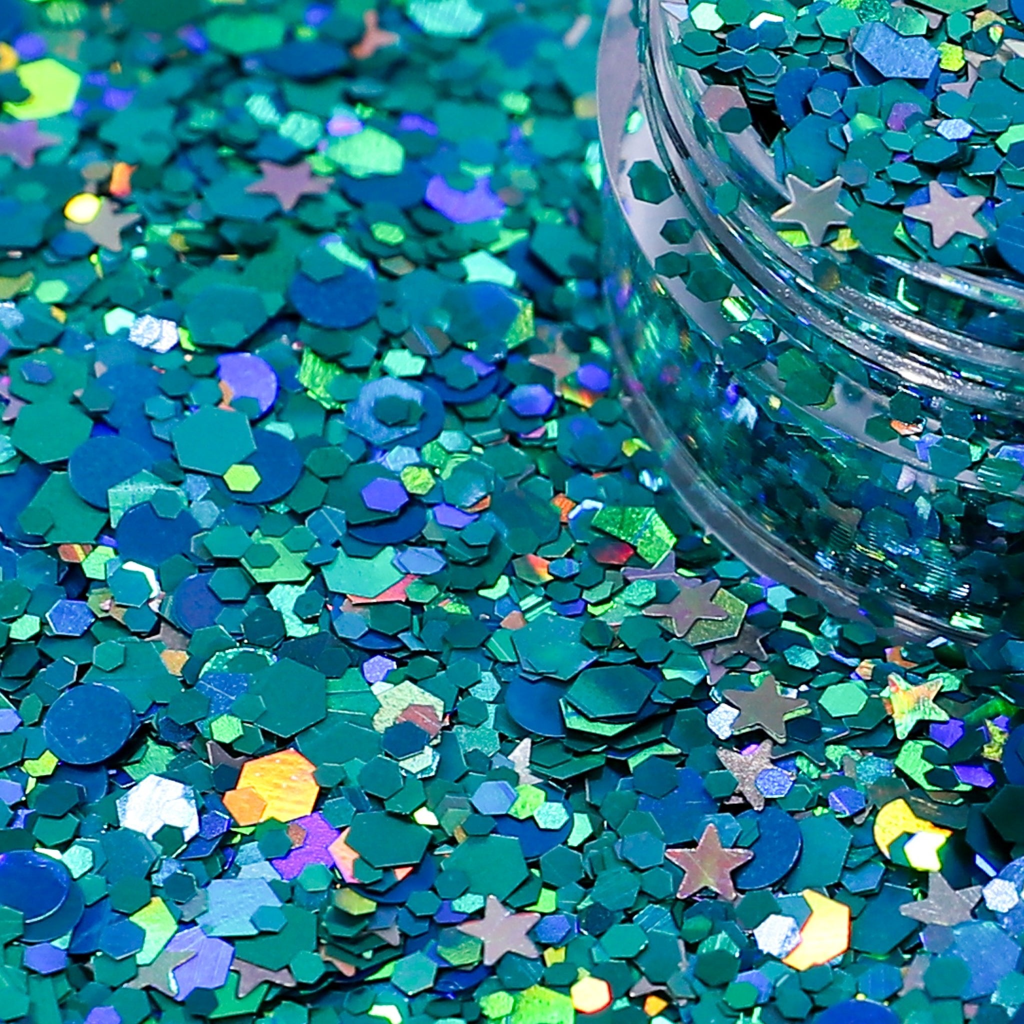 Turquoise glitter with star shapes on a blue background