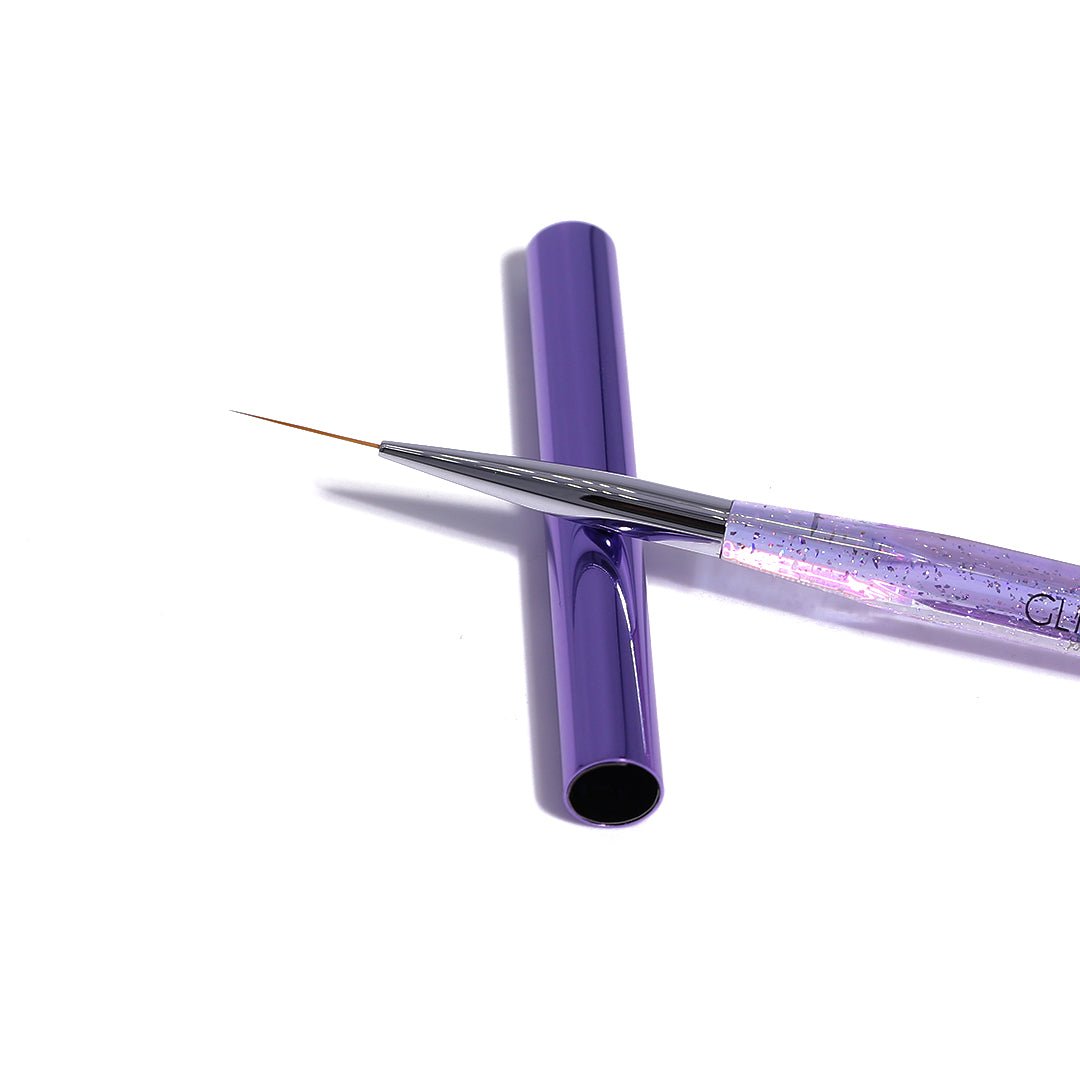 Purple nail art brush with a transparent handle on a white background