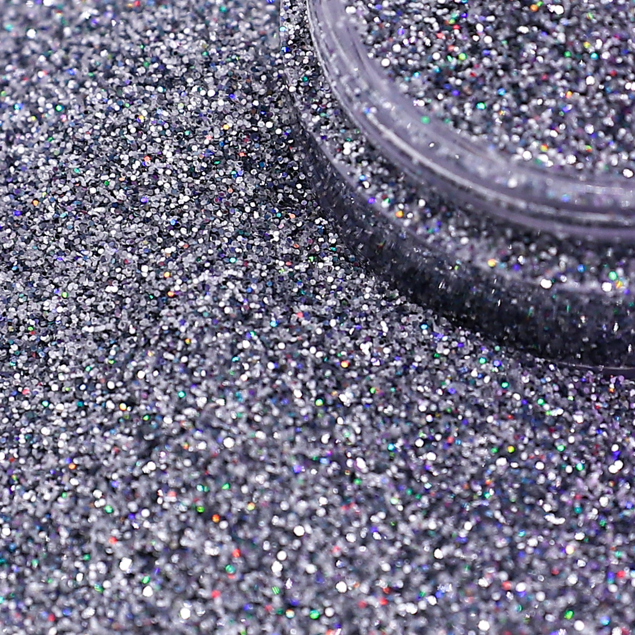 Silver glitter with a container on a textured surface