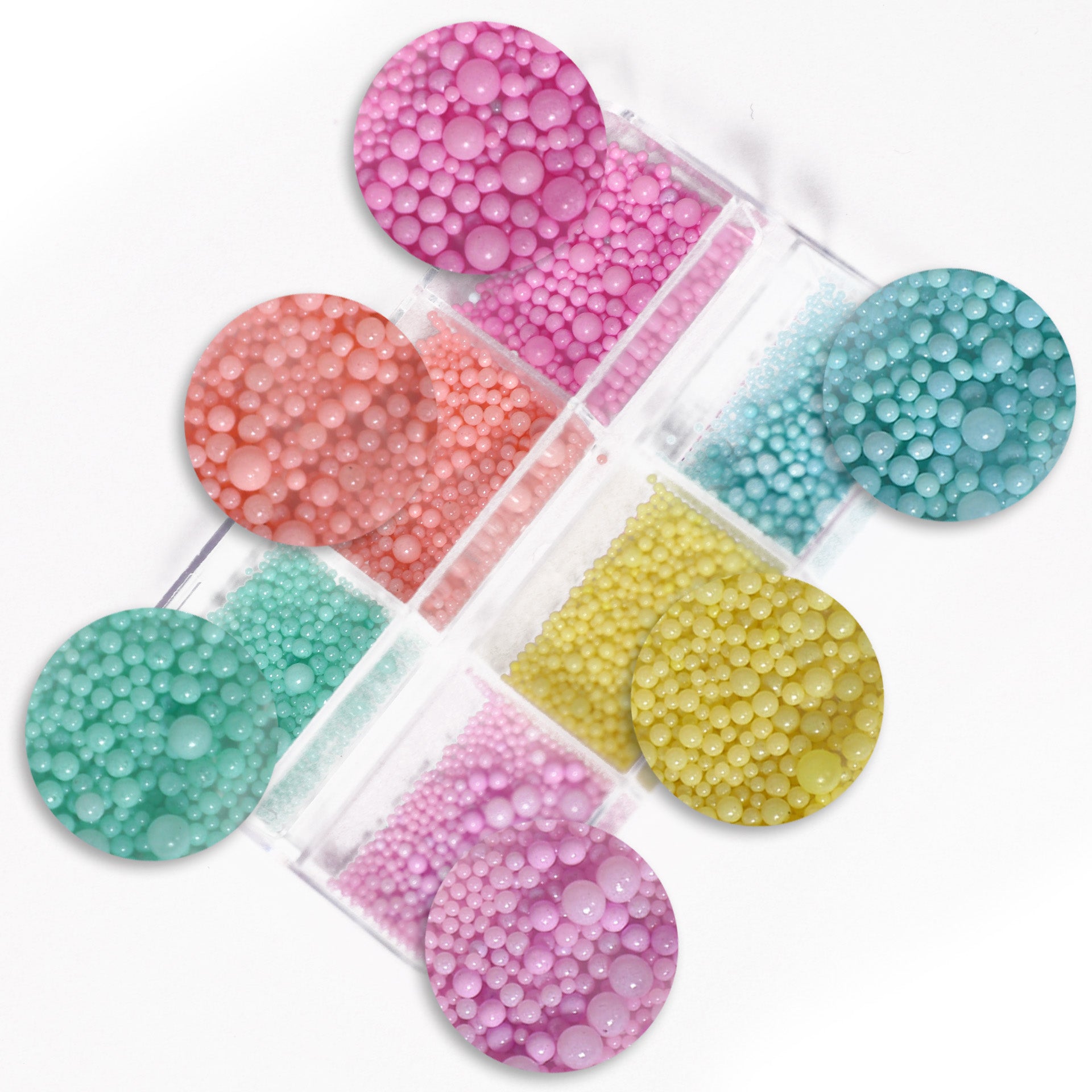 A collection of colorful candy-shaped nail art charms displayed in transparent containers.