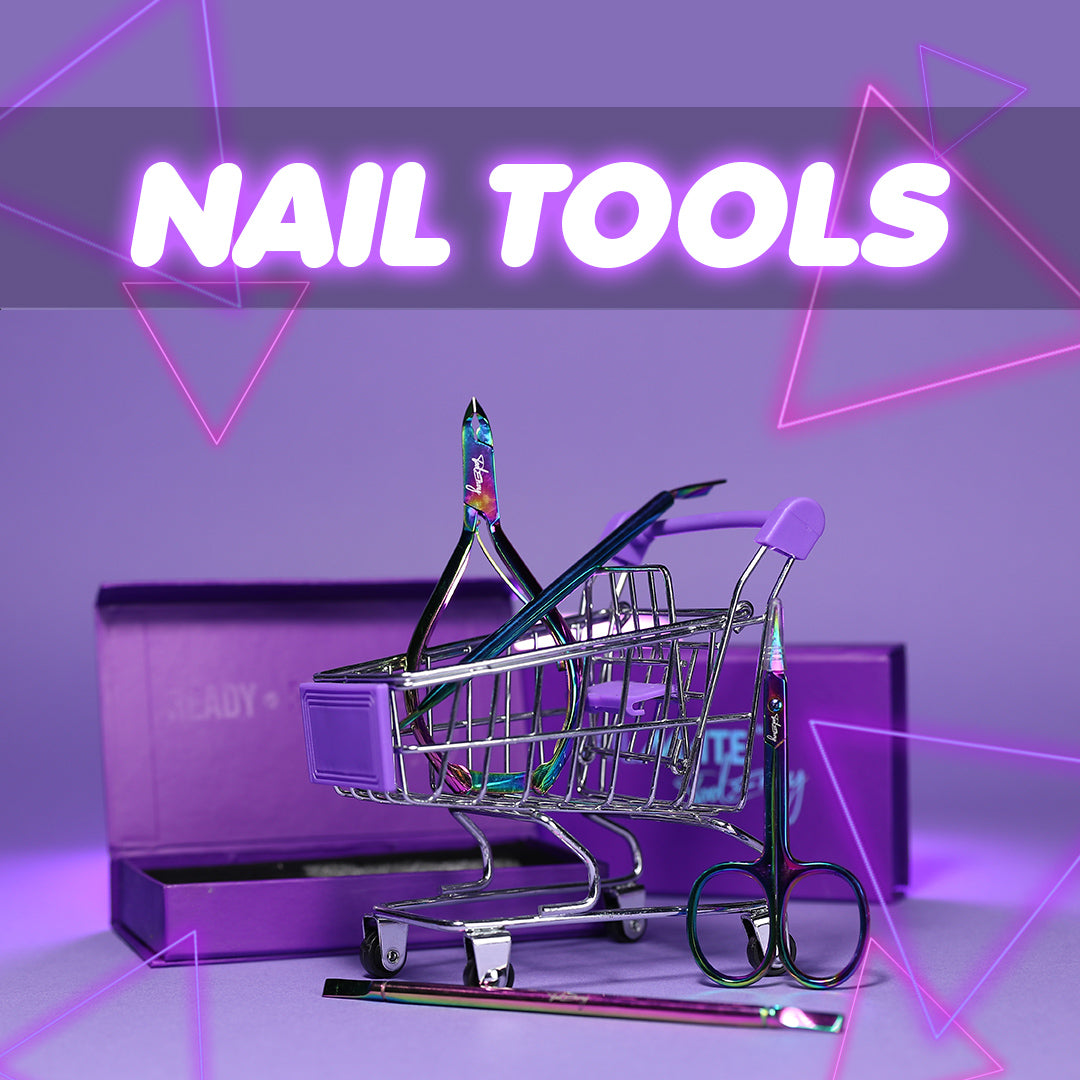 cuticle nippers and pusher nail tools in a mini trolley with boxes in the back on a lilac background