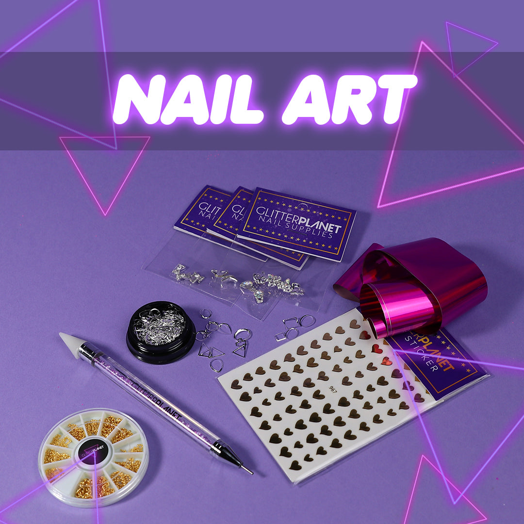 Nail art supplies for fun nail designs nail foils nail charms and stickers nail art laid down on a lilac background text says nail art