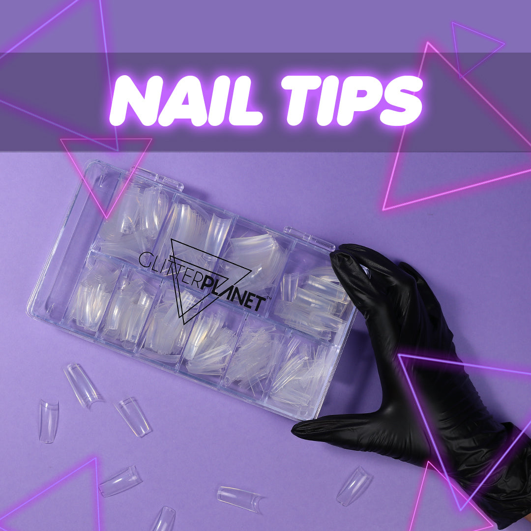a box of nail tips with some tips out of the box and a gloved hand holding the side on a lilac background