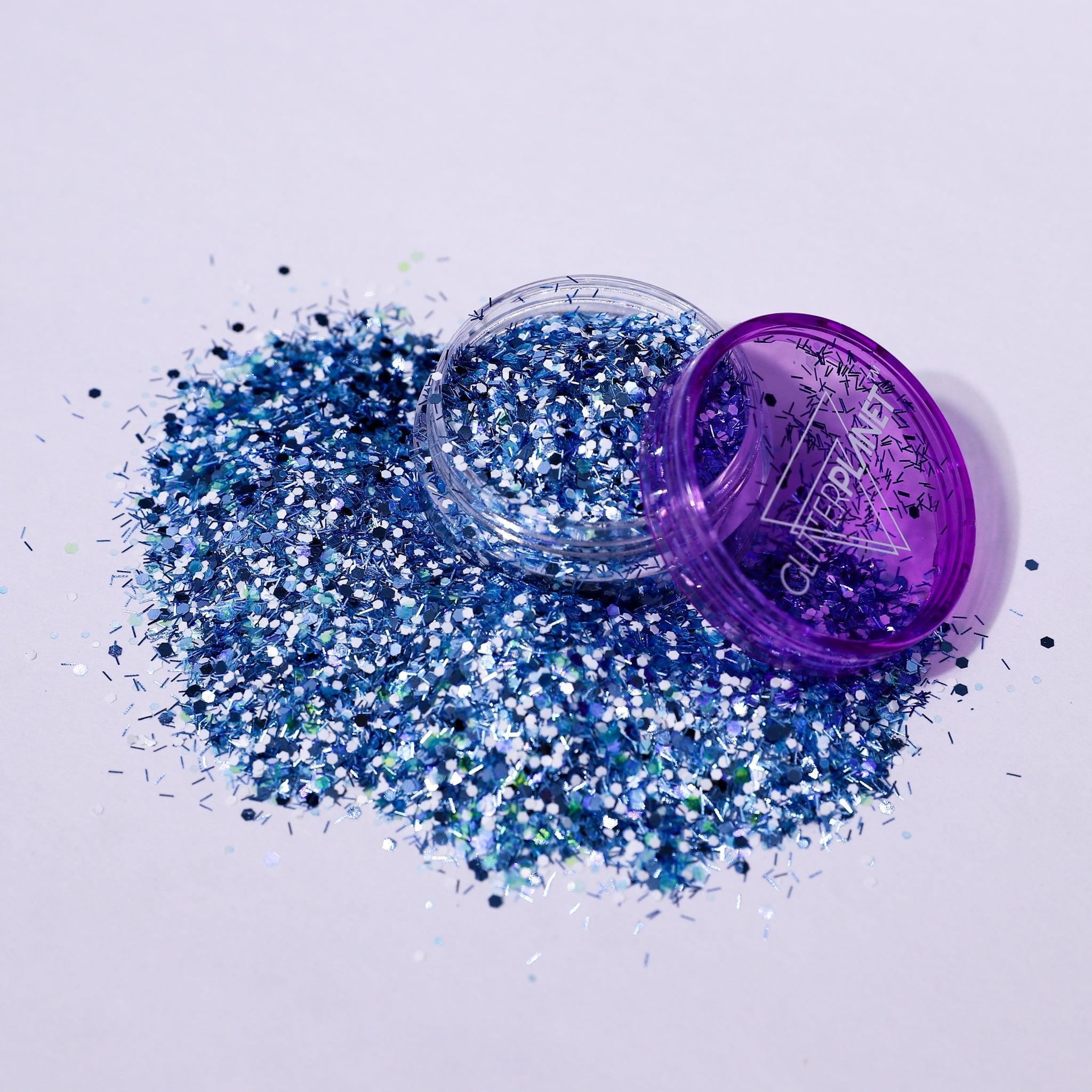 Blue glitter with a purple container on a white background