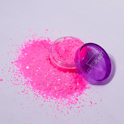 Pink glitter with a purple container on a light gray background | Glitter Planet