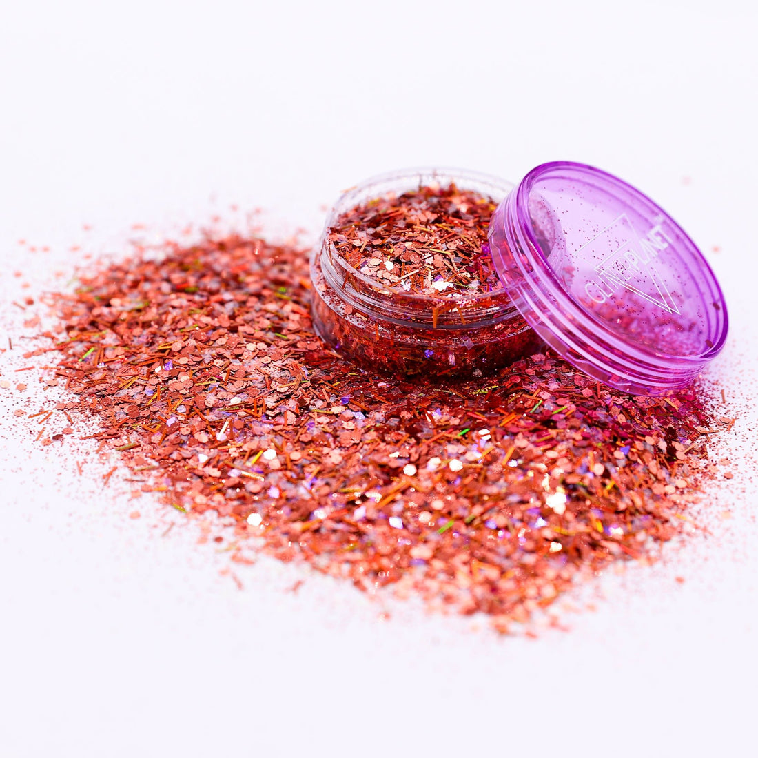 Bronze glitter jar with open lid on a white background