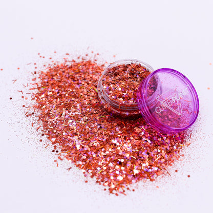 Pink glitter with an open container on a white background