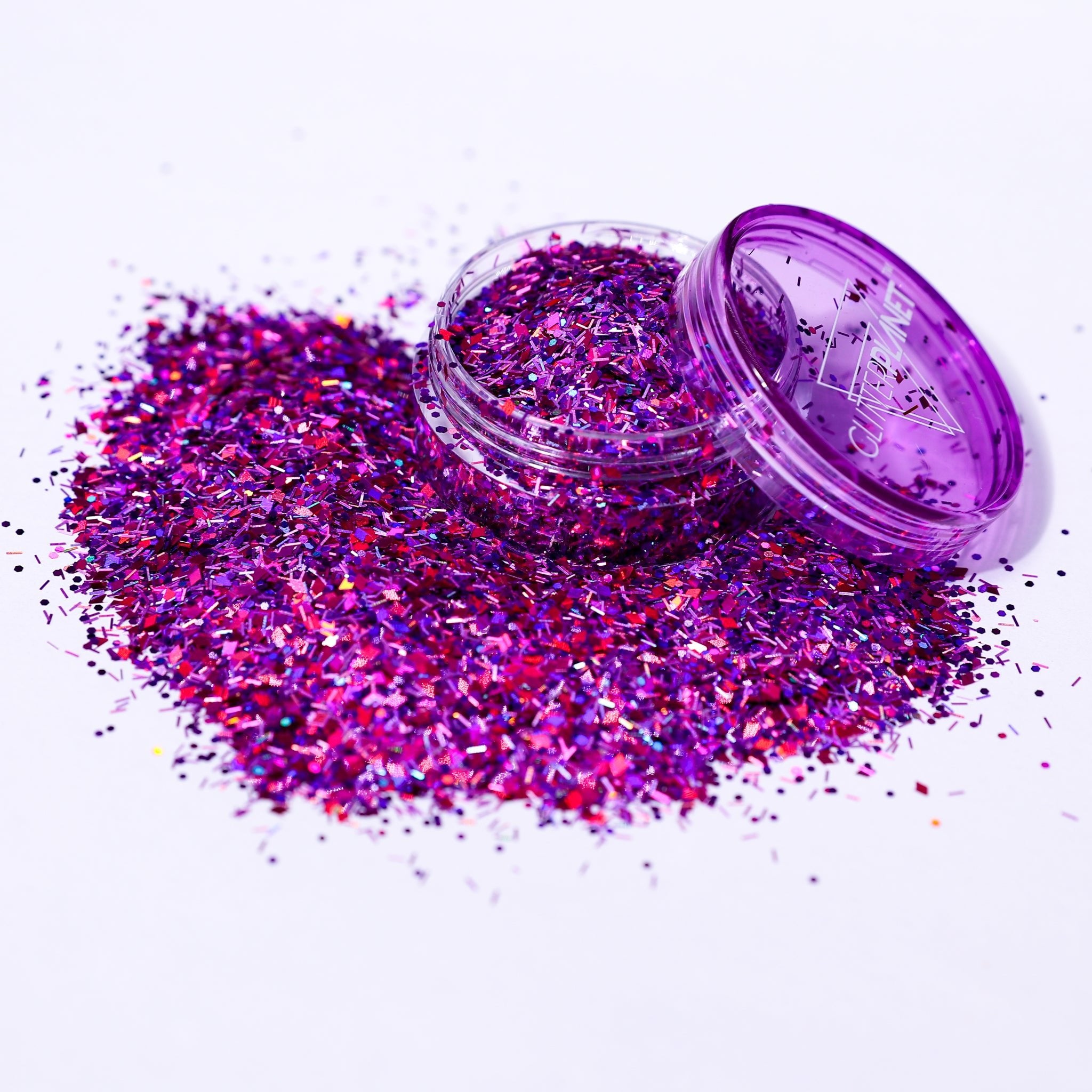 Purple glitter in an open container on a white background