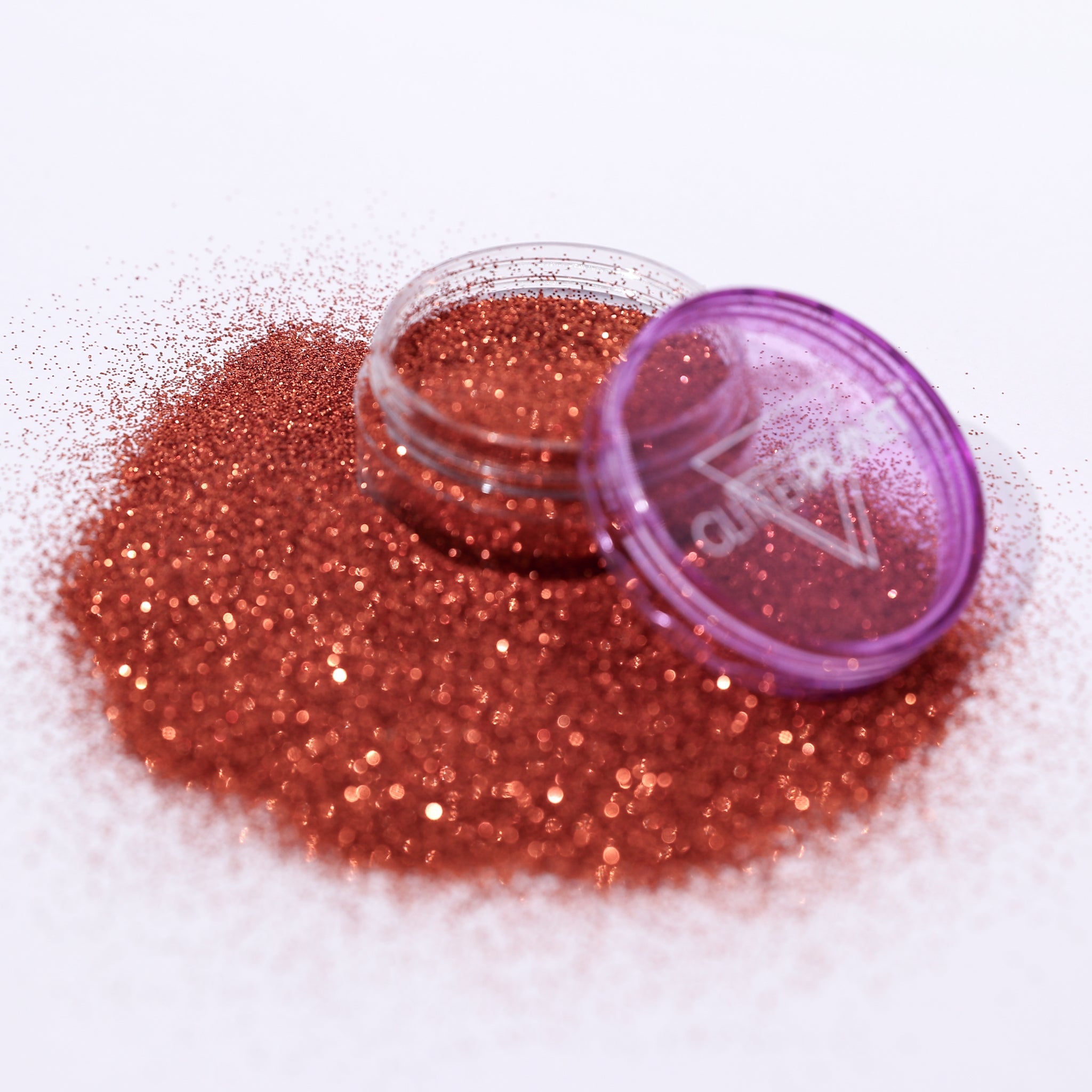 copper glitter with a purple lid on a white background