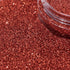 Close-up of copper glitter with a clear container glitter background