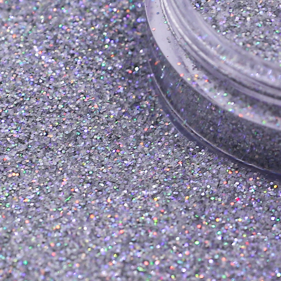 Close-up of silver glitter with a clear container partially filled with glitter | Glitter Planet