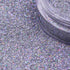 Close-up of silver glitter with a clear container partially filled with glitter | Glitter Planet