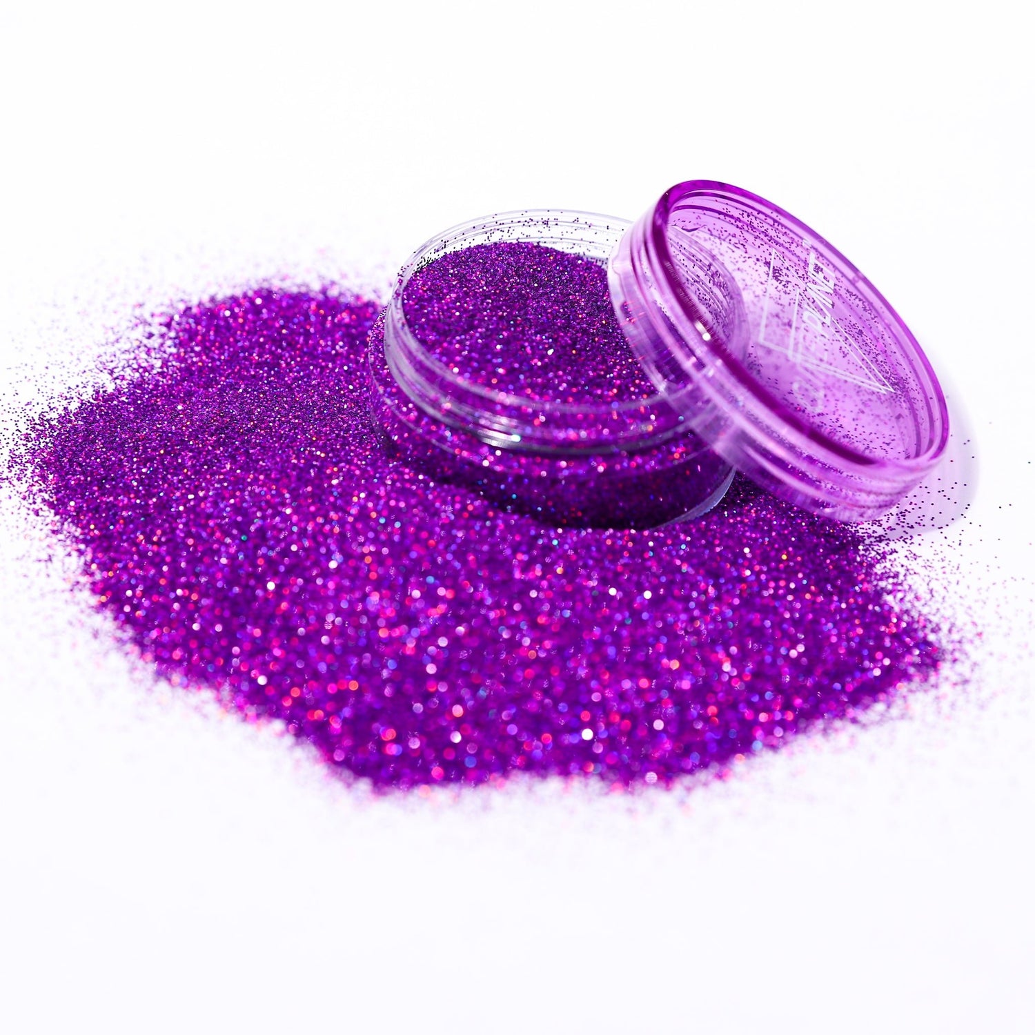 Purple glitter in an open container on a white background