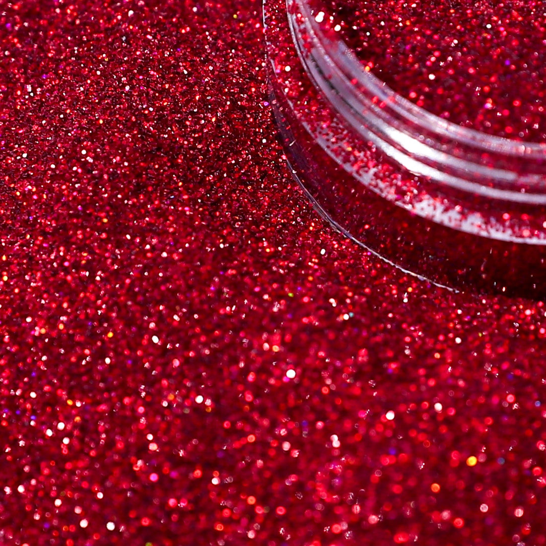 Close-up of red glitter with a clear container.