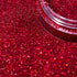 Close-up of red glitter with a clear container.