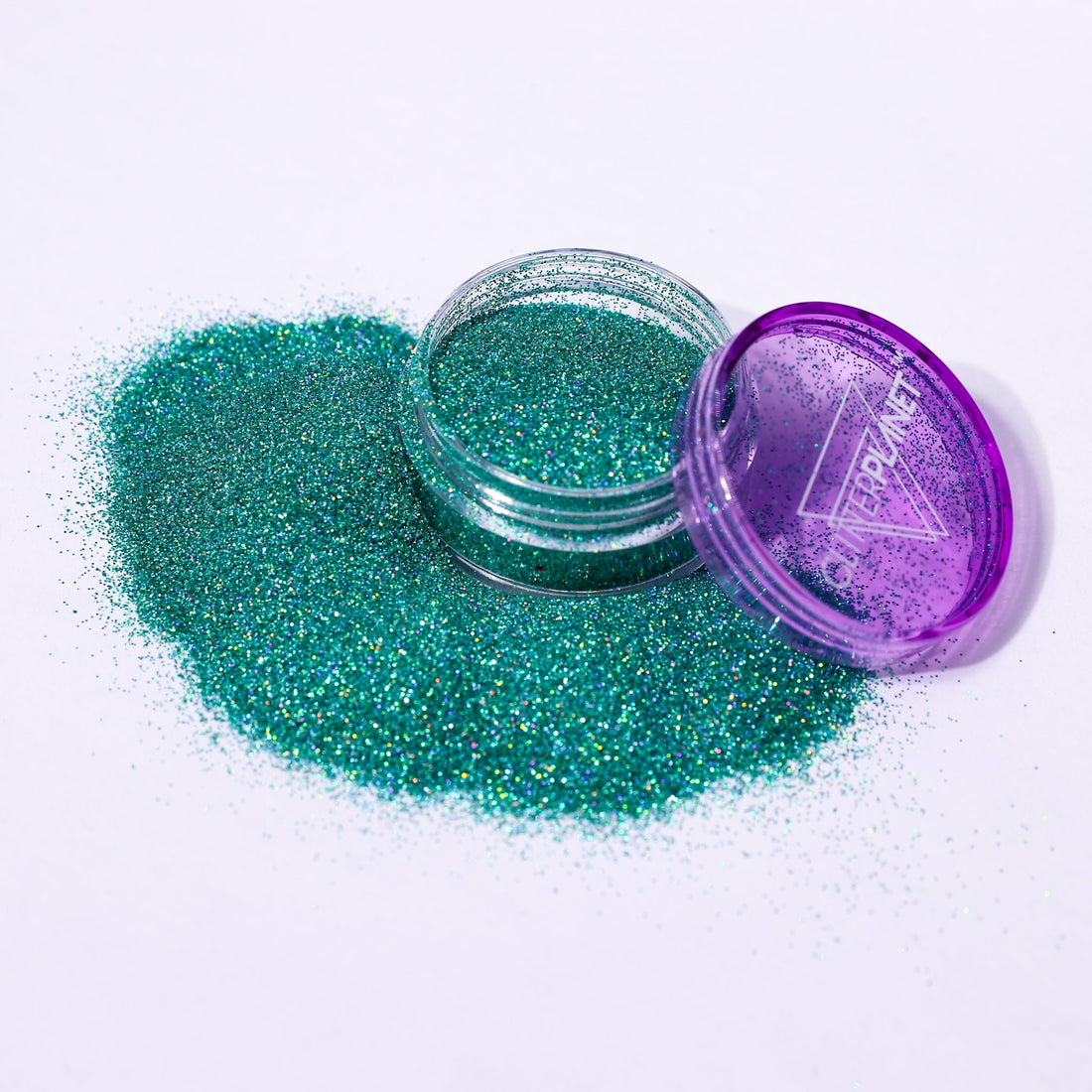 Green glitter in an open purple container on a white background | Glitter Planet