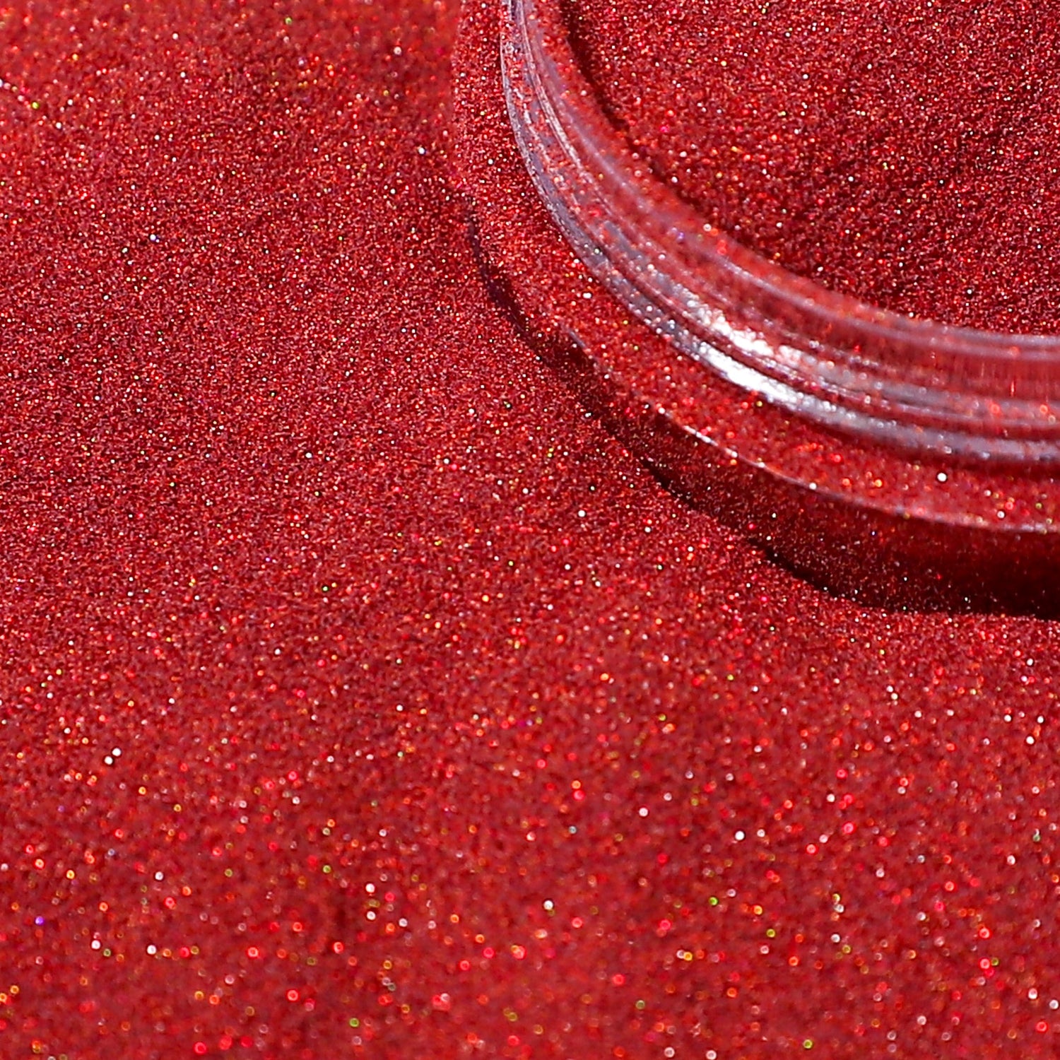 Close-up of red glittery powder with a clear container on a red background