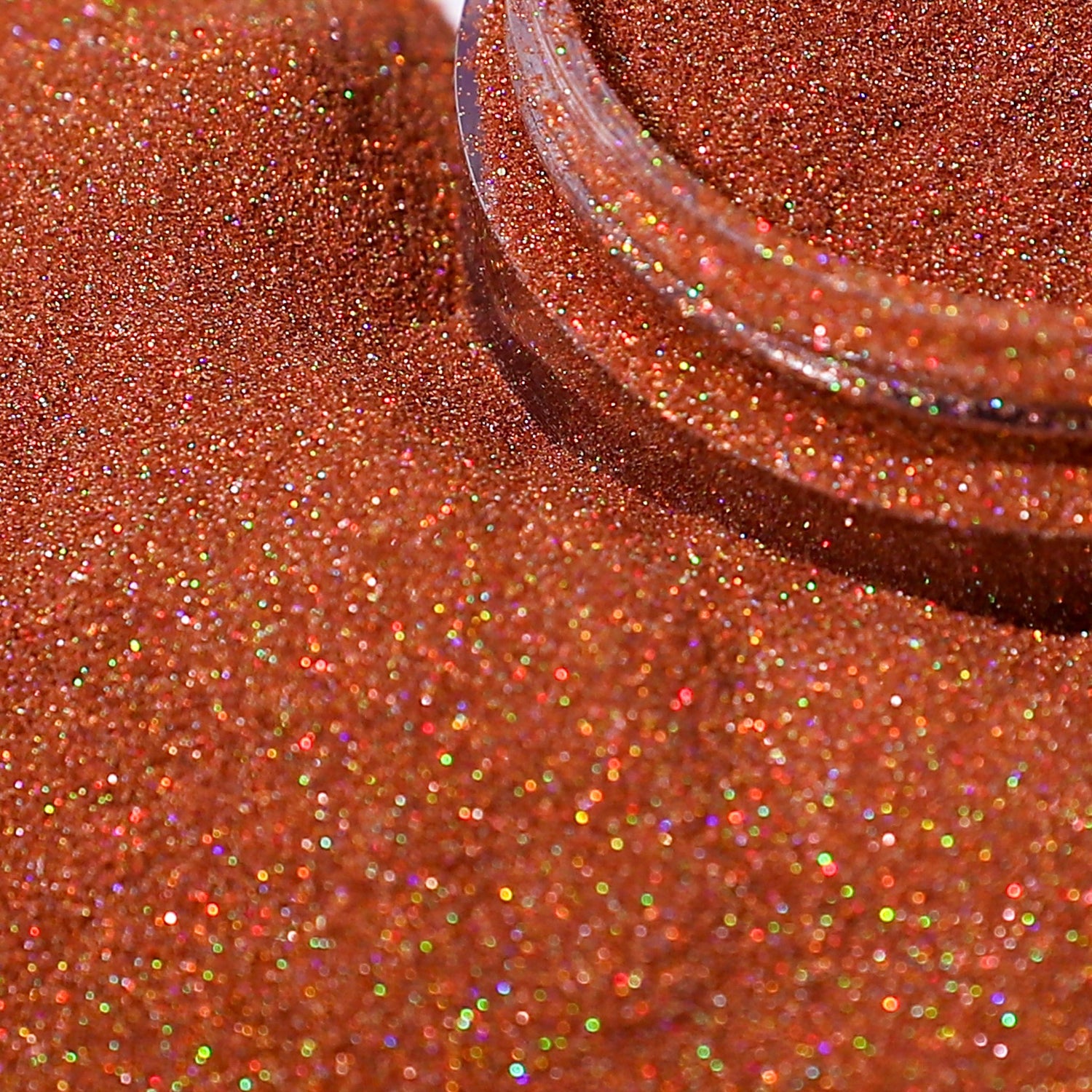 Close-up of a container of red glitter on a textured red surface
