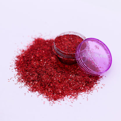 Red glitter with a purple lid on a white background