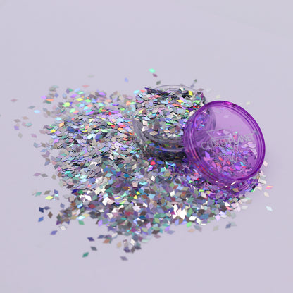 silver holo glitter container with scattered glitter on a light gray background