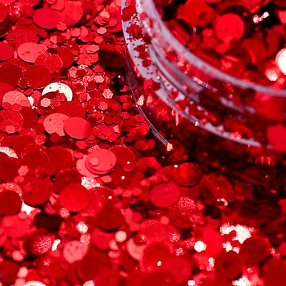 Red glitter with a clear container partially filled with glitter