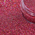 Close-up of Rose Pink glitter with a clear container partially filled with glitter.