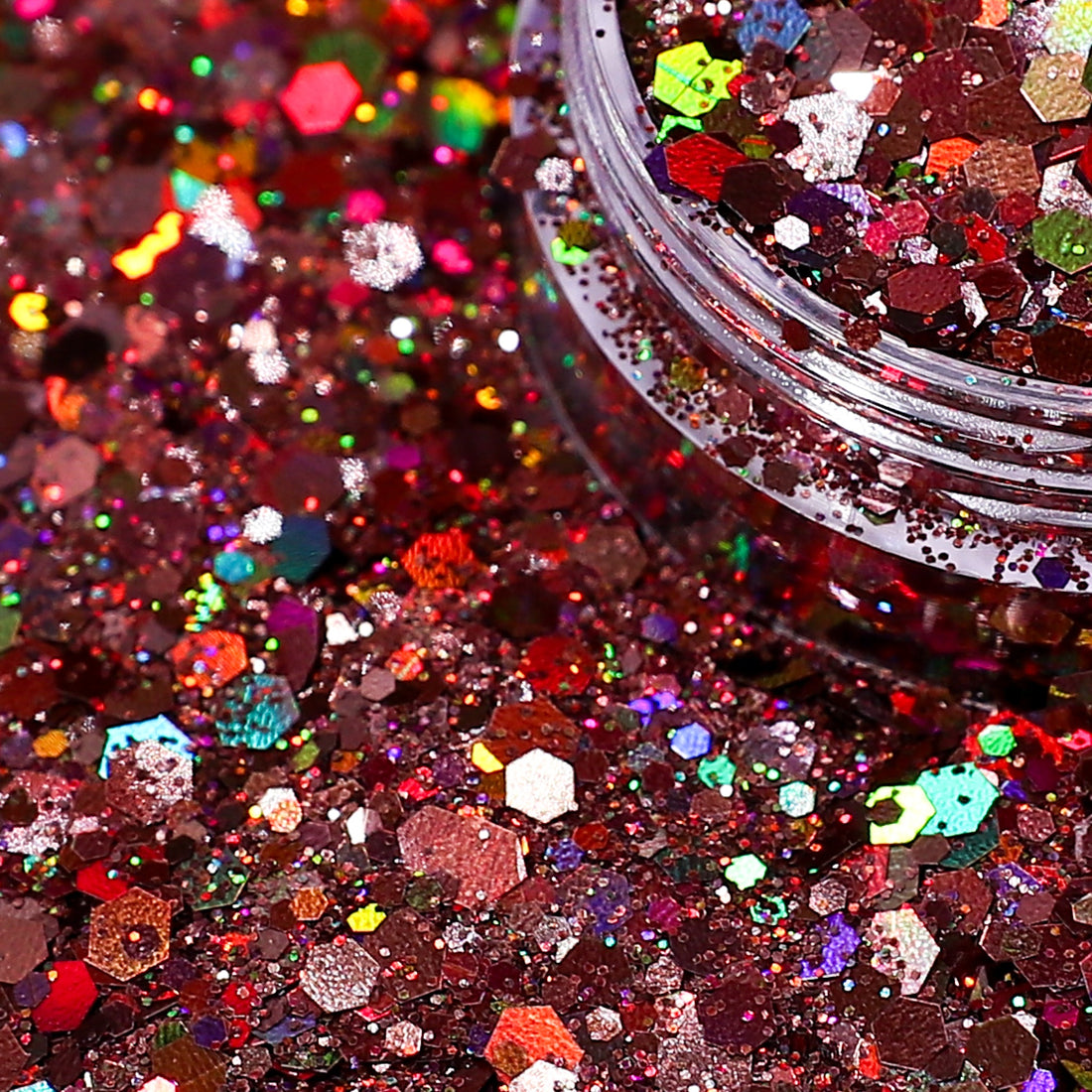 Close-up of multicolored glitter with a jar partially filled with glitter.