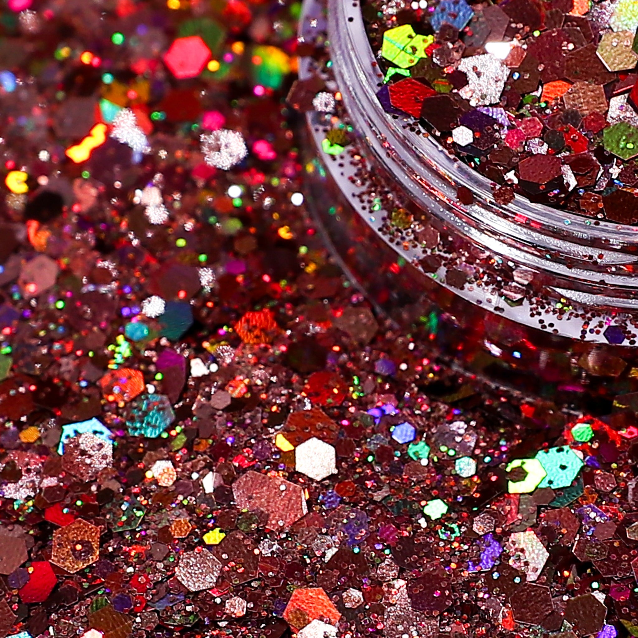 Close-up of multicolored glitter with a jar partially filled with glitter.