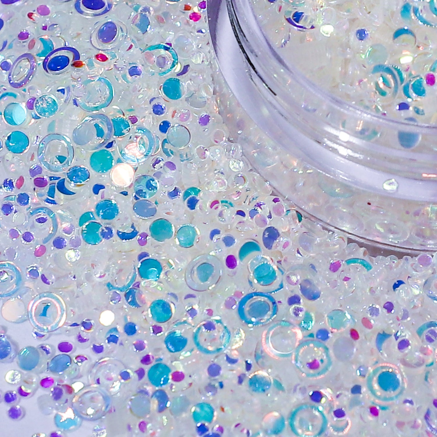 Colorful glitter with a jar on a white background