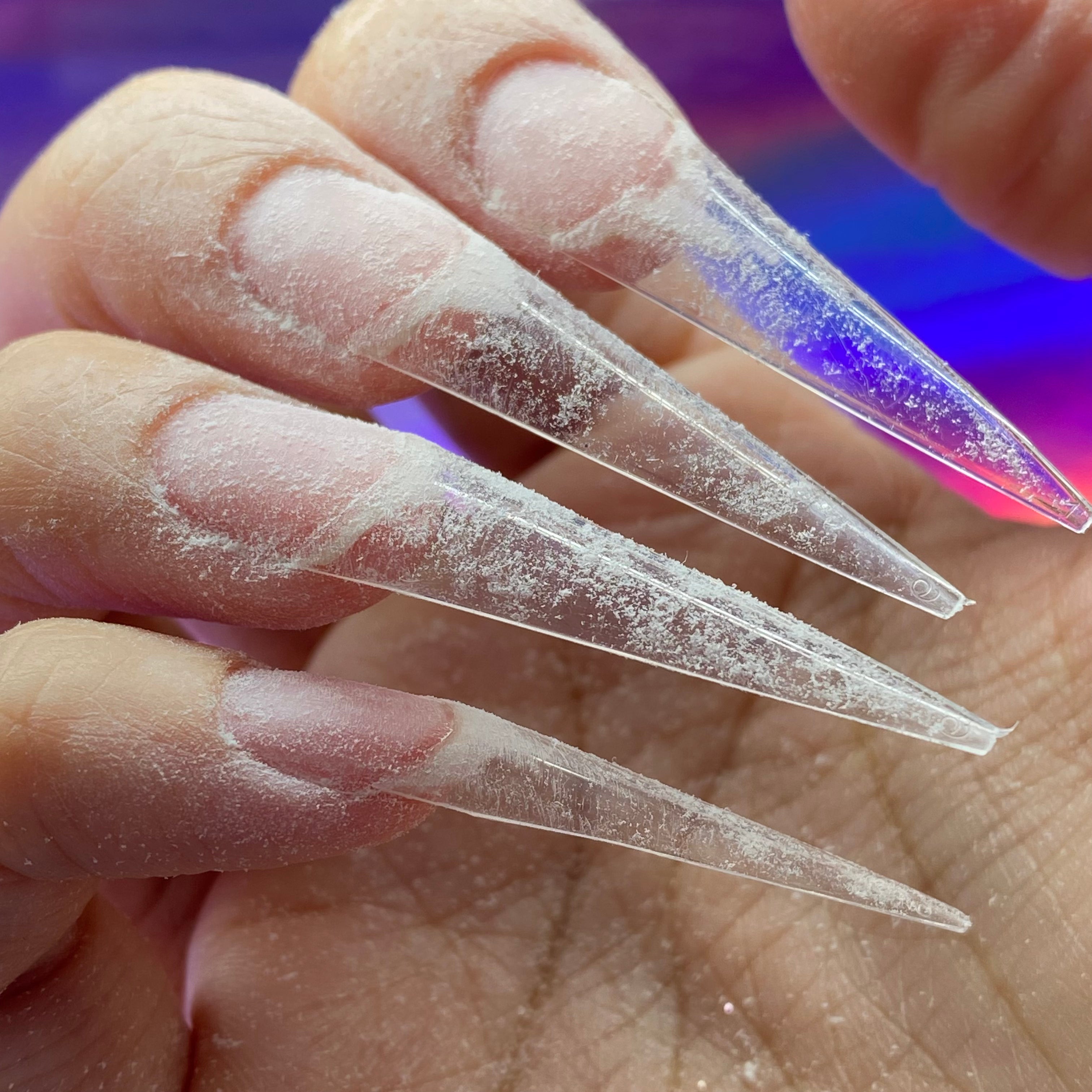 long clear stiletto nail tips applied to the end of the natural nails