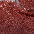 Close-up of caramel glitter with a clear container.