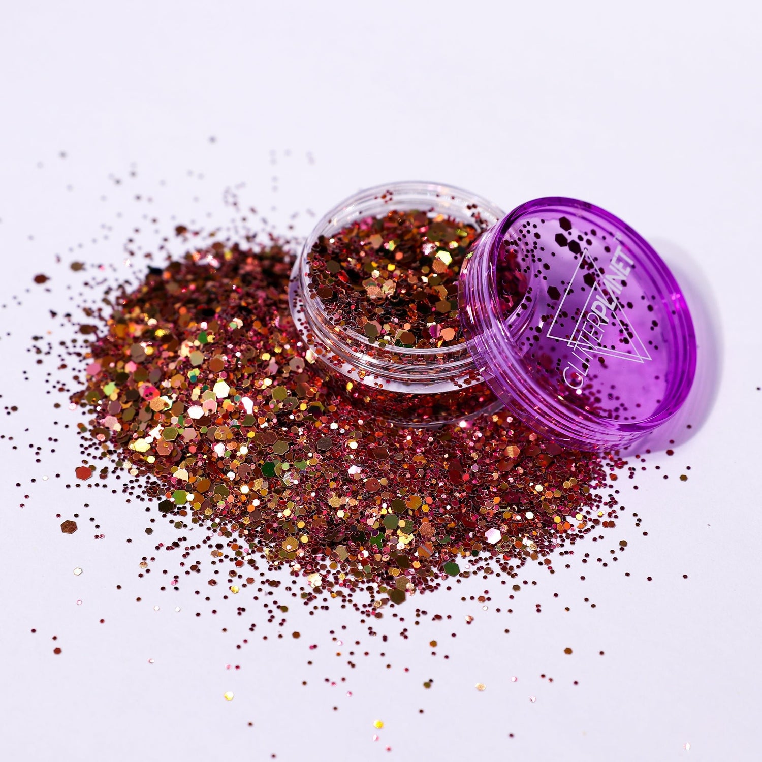 Glitter jar with purple lid on a white background