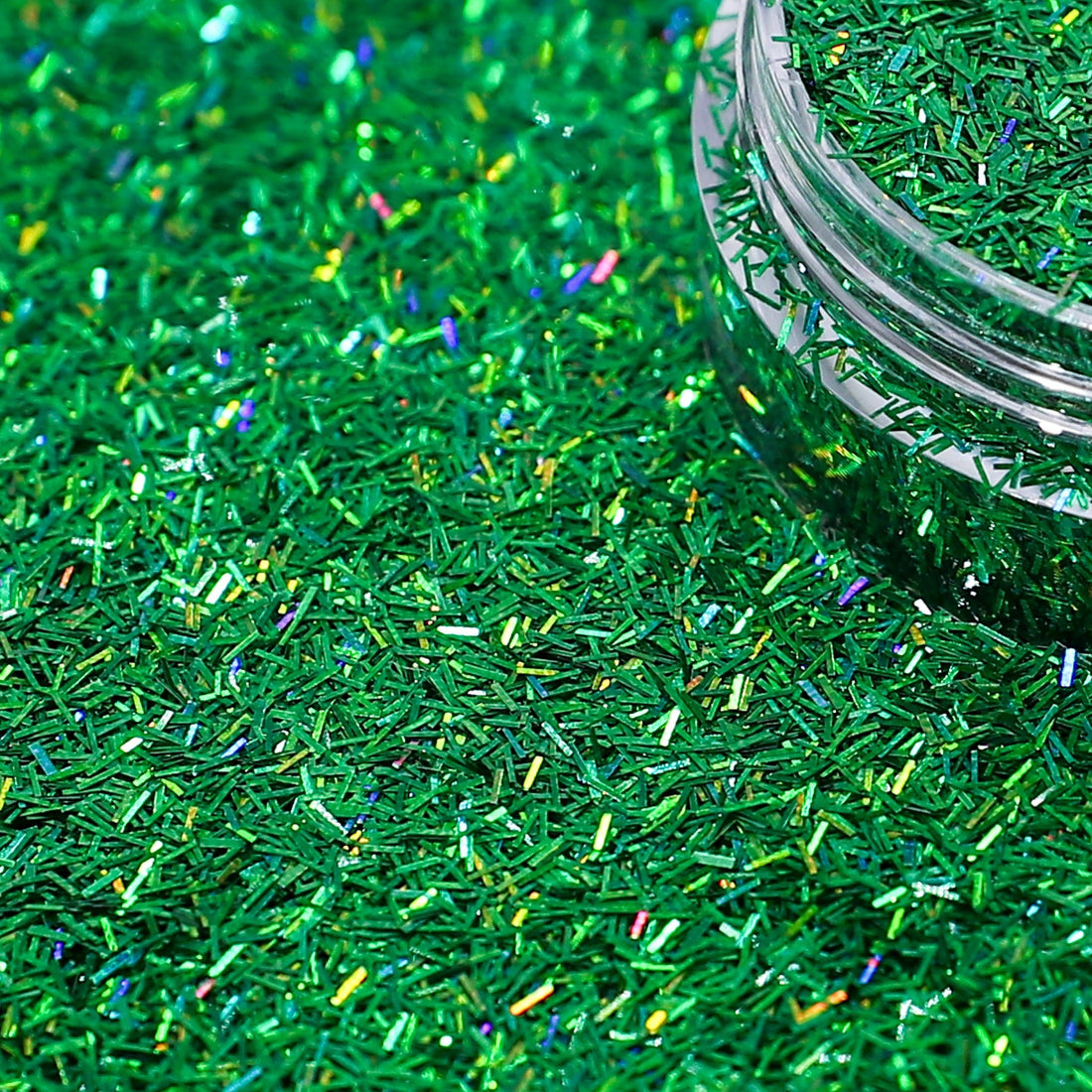 Green glittery sprinkles with a clear jar in the background