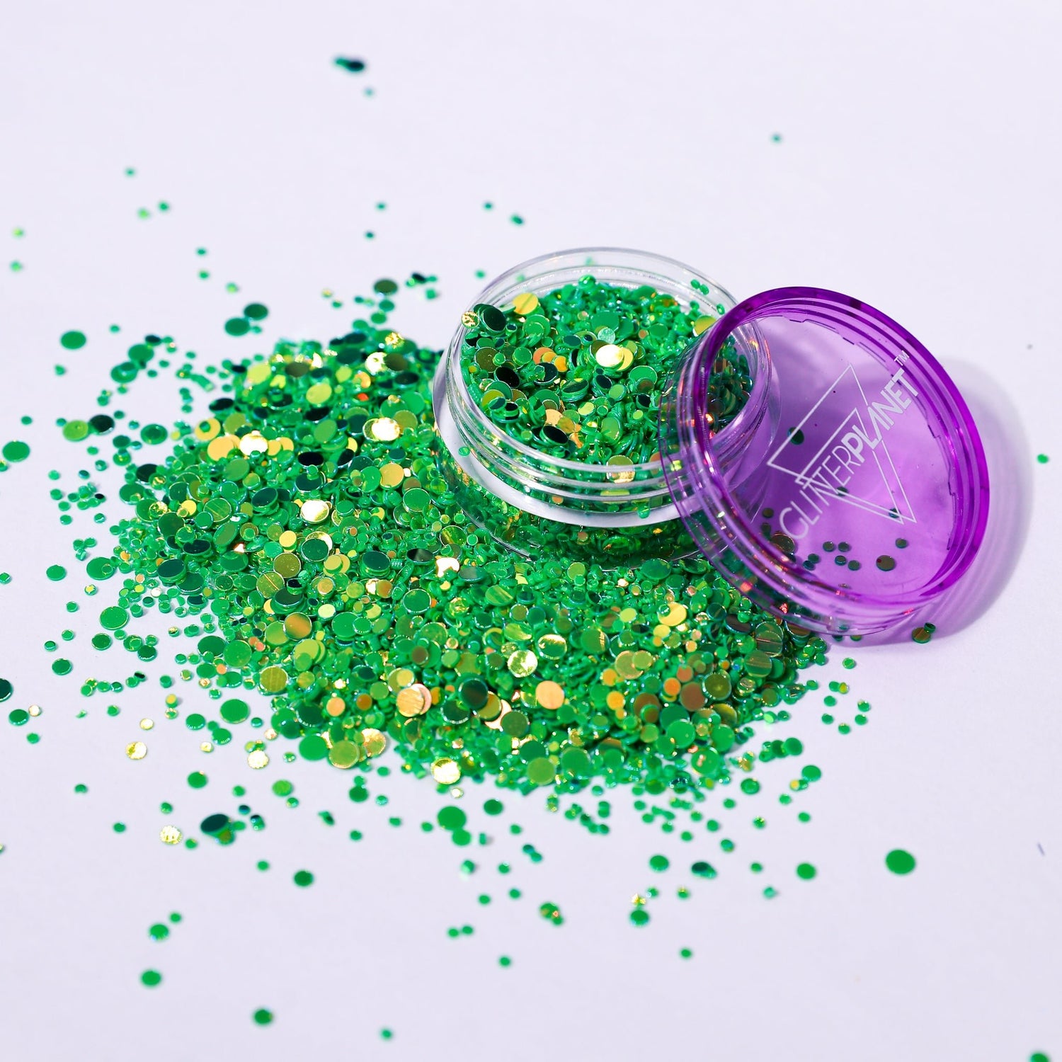 Green glitter with a purple lid on a white background
