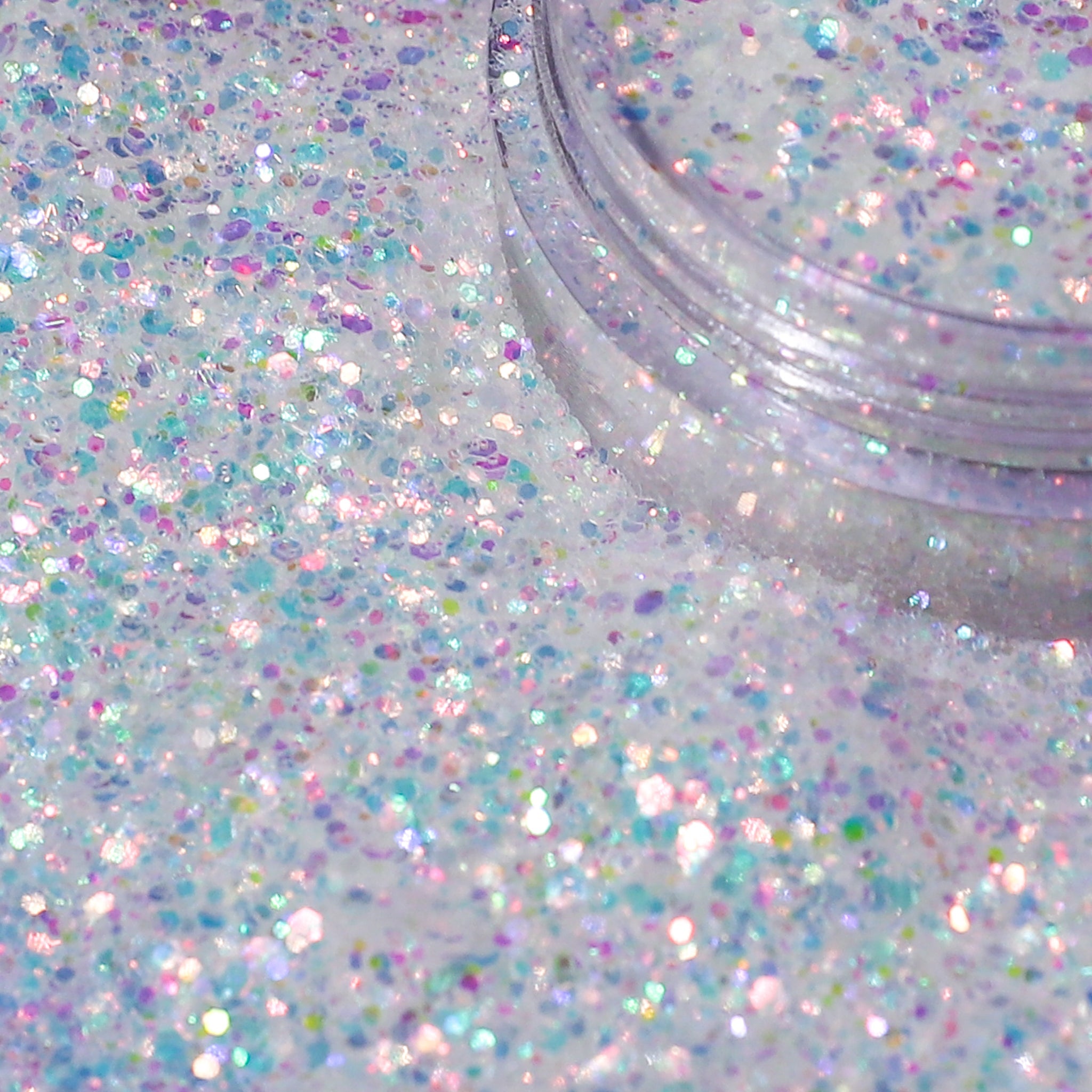 Multicolored glitter in a clear container on a white background