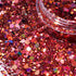 Close-up of pink glitter with a clear container partially filled with glitter.