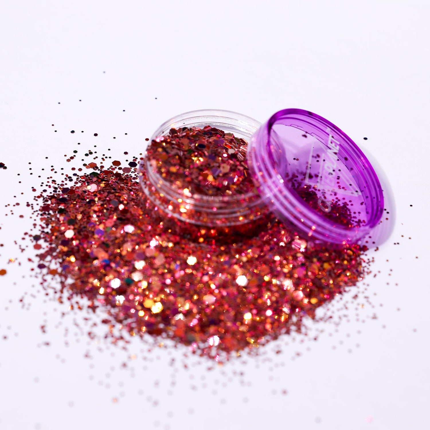 Rose gold glitter with a purple lid on a white background