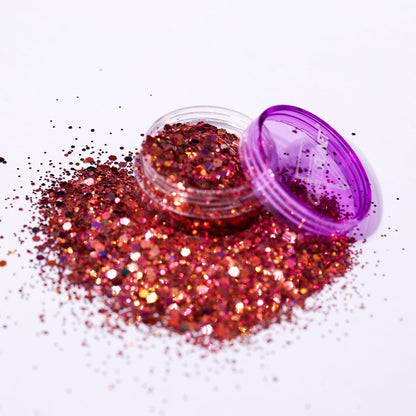 Rose gold glitter with a purple lid on a white background
