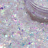Iridescent glitter on a white background with a container of glitter.